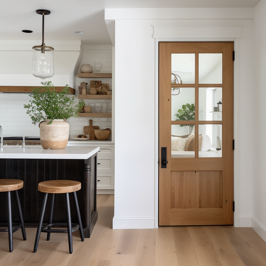 An oak bespoke custom handcrafted wood and glass interior door. Shown in a country french modern farmhouse clean kitchen.