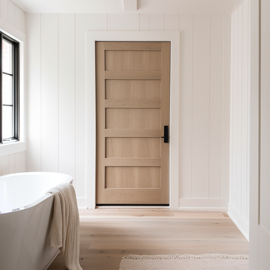 A handcrafted custom 5 panel white oak bespoke interior door. Pictured in a minimalist white modern farmhouse bathroom door